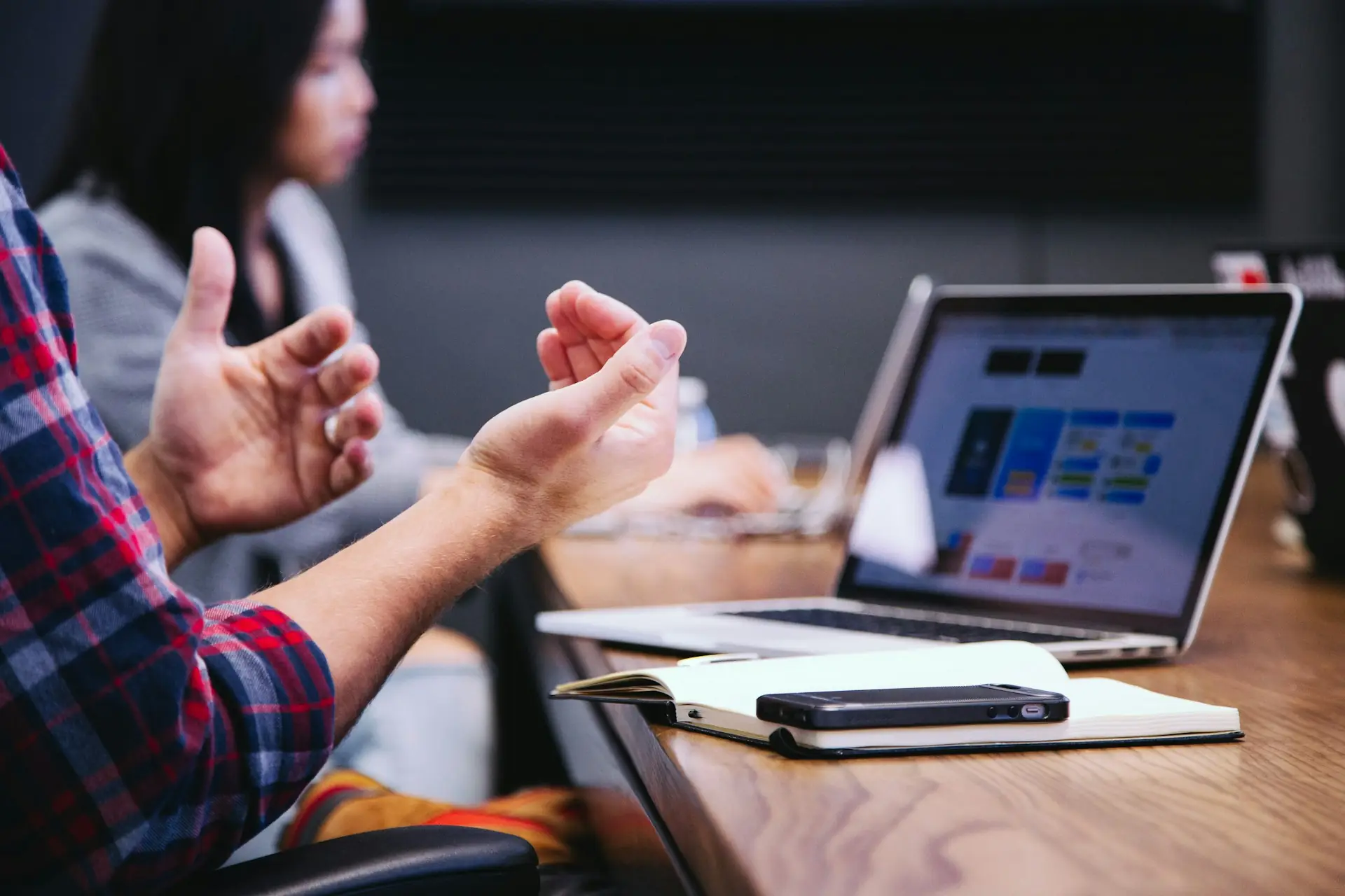 Technology professional gesturing in a modern workspace